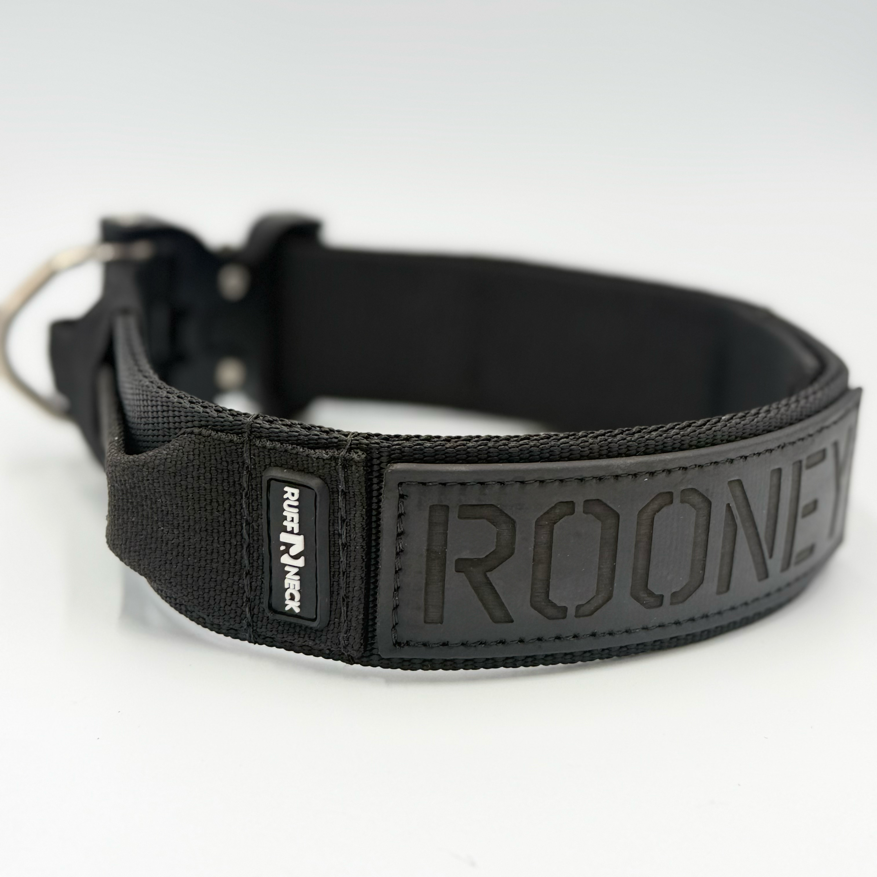 Titan Tactical Elite Dog Collar featuring 1.75" Mil-Spec Type 13 nylon webbing, a genuine AustriAlpin COBRA® Integrated D-Ring Buckle, RuffLock Retained Handle System, and the exclusive RuffTag Personalized BioThane Identification System. Handmade in the USA by American Ruffneck Collars. Side view of Rufflock Retaining System.
