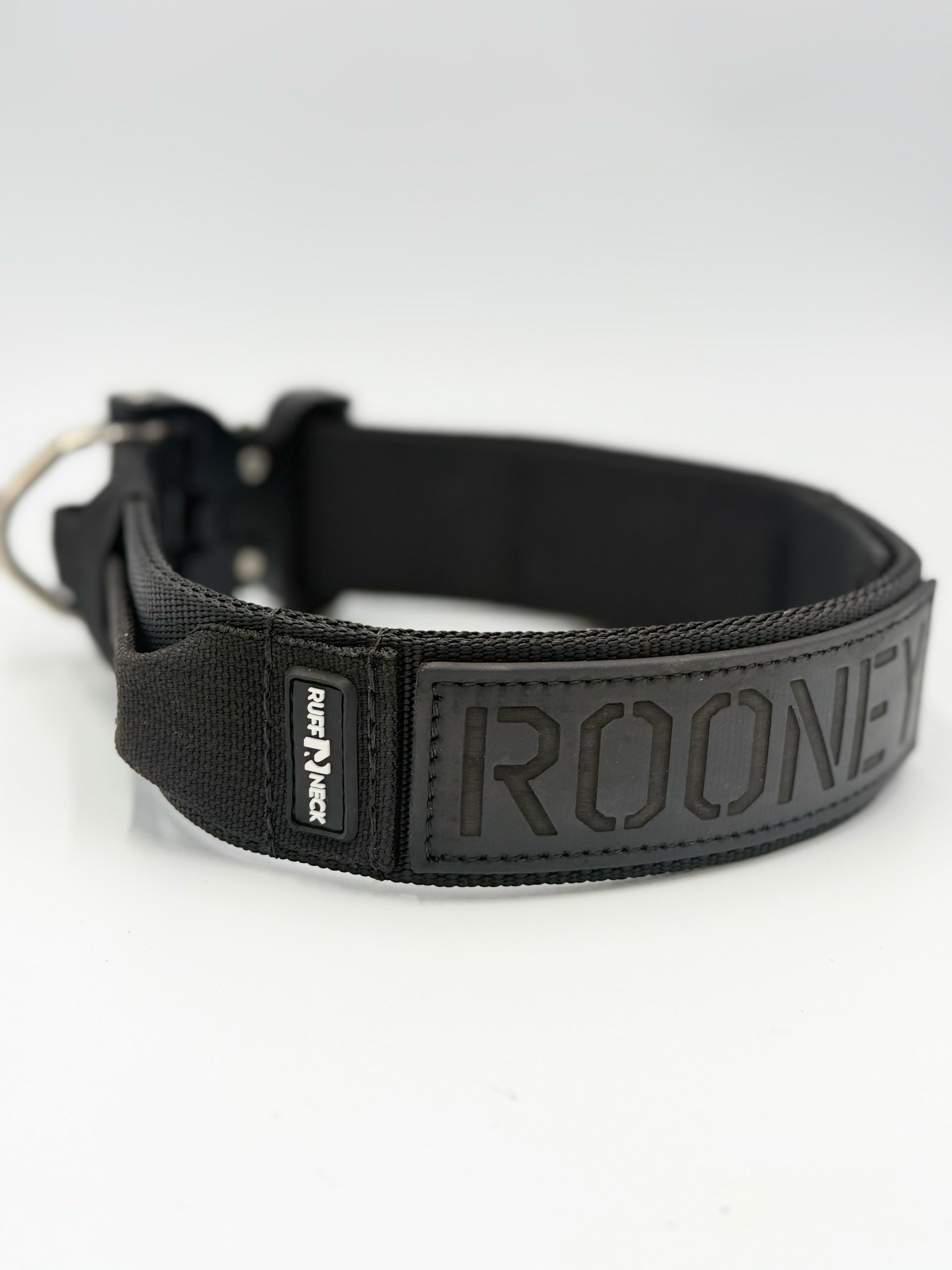 Titan Tactical Elite Dog Collar featuring 1.75" Mil-Spec Type 13 nylon webbing, a genuine AustriAlpin COBRA® Integrated D-Ring Buckle, RuffLock Retained Handle System, and the exclusive RuffTag Personalized BioThane Identification System. Handmade in the USA by American Ruffneck Collars. Side view of Rufflock Retaining System.