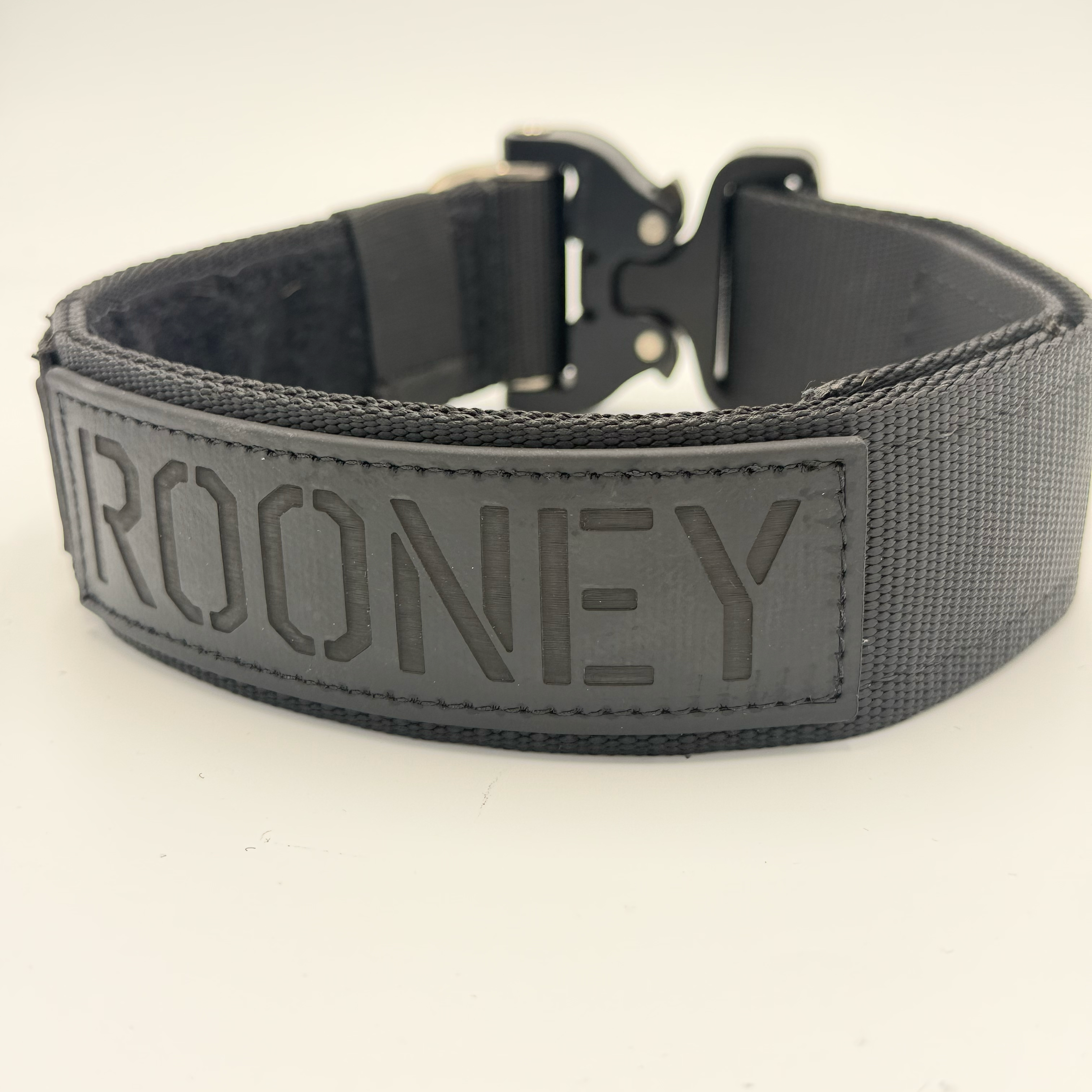 Titan Tactical Elite Dog Collar featuring 1.75" Mil-Spec Type 13 nylon webbing, a genuine AustriAlpin COBRA® Integrated D-Ring Buckle, RuffLock Retained Handle System, and the exclusive RuffTag Personalized BioThane Identification System. Handmade in the USA by American Ruffneck Collars. Rear view.