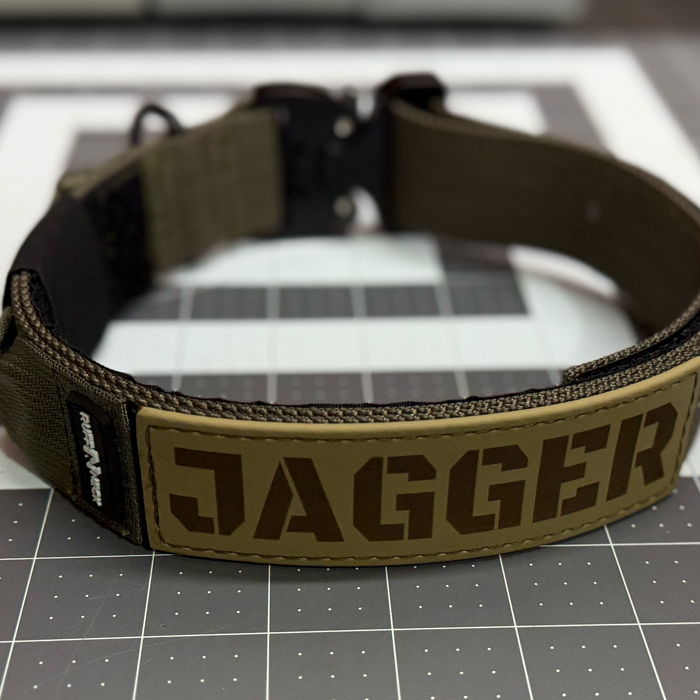 Titan Tactical Dog Collar featuring 1.5" Mil-Spec 4015 nylon webbing, a genuine AustriAlpin COBRA® buckle, RuffLock Retained Handle System, and the exclusive RuffTag Personalized BioThane Identification System. Handmade in the USA by American Ruffneck Collars.