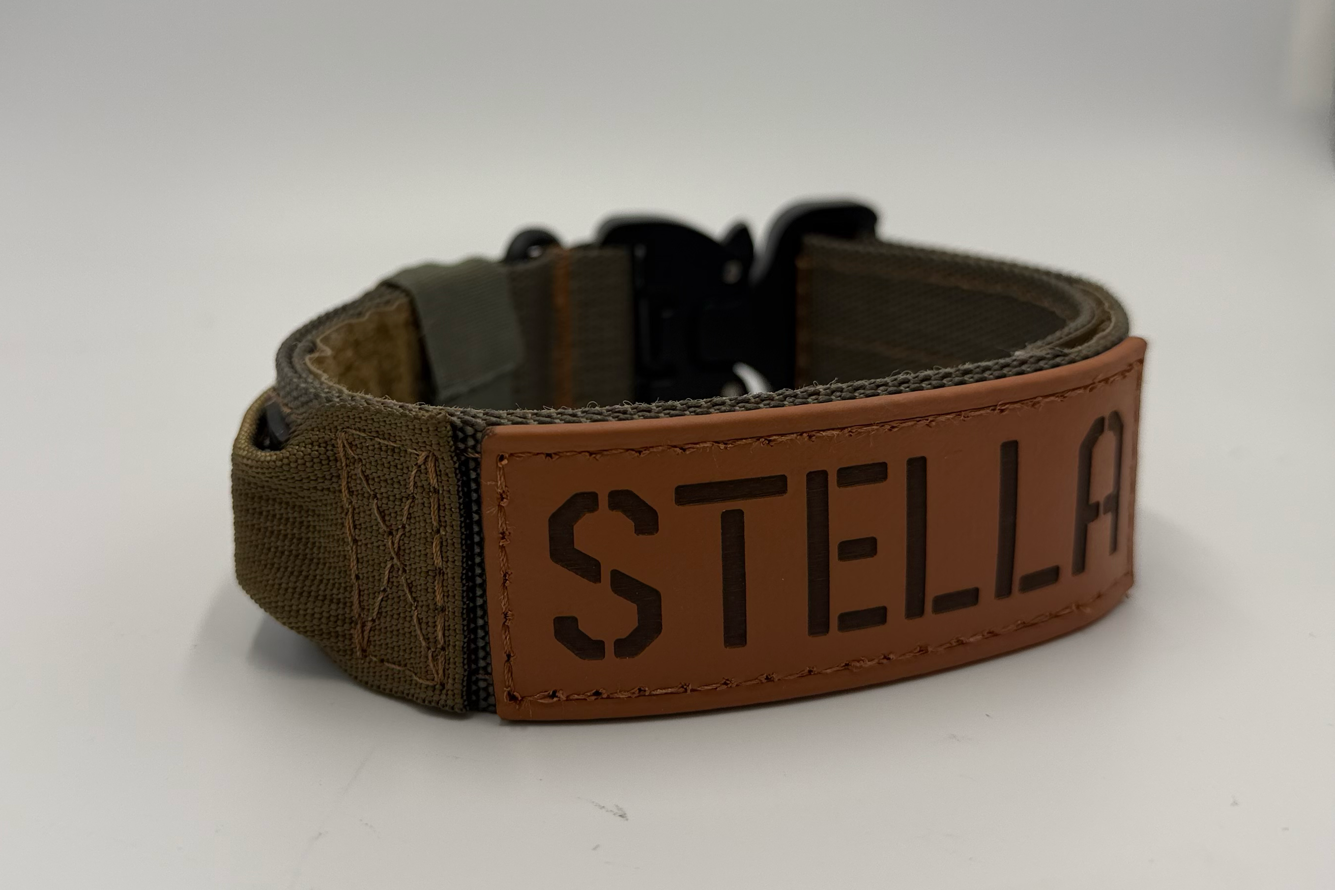 Titan Tactical Dog Collar featuring 1.5" Mil-Spec 4015 nylon webbing, a genuine AustriAlpin COBRA® buckle, RuffLock Retained Handle System, and the exclusive RuffTag Personalized BioThane Identification System. Handmade in the USA by American Ruffneck Collars. Biothane Tag close up.
