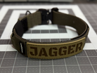 Titan Tactical Dog Collar featuring 1.5" Mil-Spec 4015 nylon webbing, a genuine AustriAlpin COBRA® buckle, RuffLock Retained Handle System, and the exclusive RuffTag Personalized BioThane Identification System. Handmade in the USA by American Ruffneck Collars.